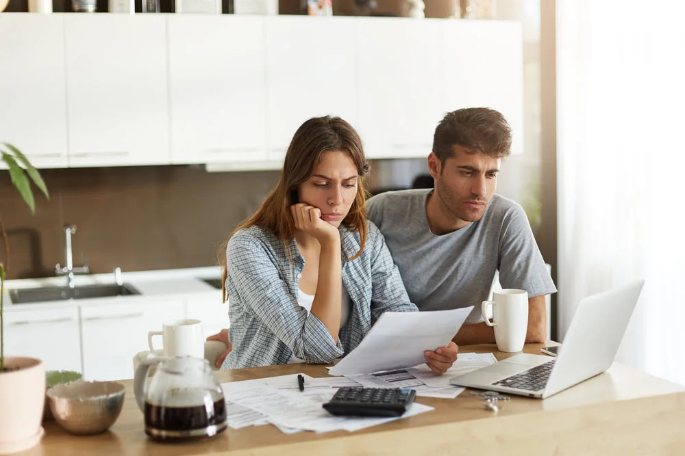 Two adults reading insurance information together at home