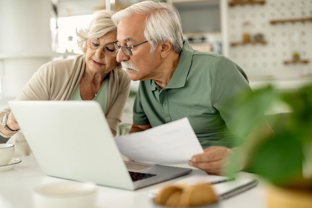 Two adults discussing paperwork in a calm home setting